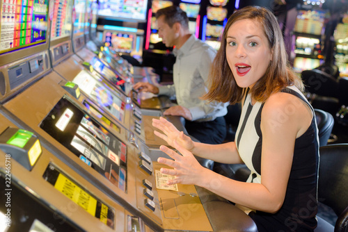 Woman playing arcade machine, surprised expression Free Download Woman playing arcade machine, surprised expression - GFXLoad