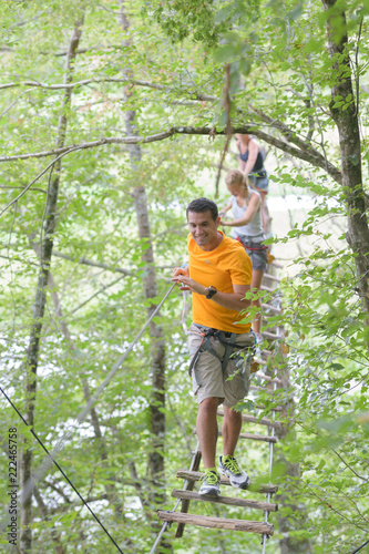 family climbing rope at the adventure park © auremar
