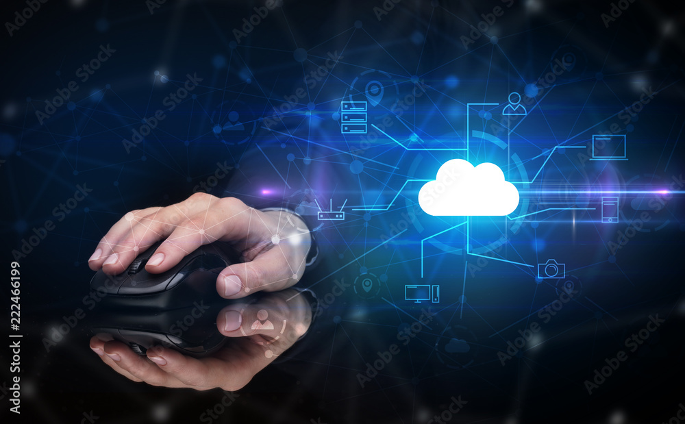 Hand using wireless mouse in a dark environment with cloud technology and online storage concept