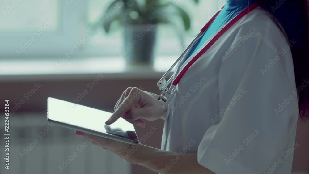 Doctor working on a digital tablet with copy space