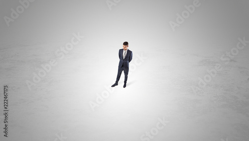 Young businessman standing alone in the middle of an empty space  