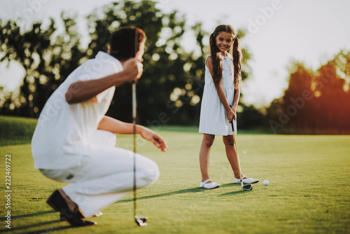 Happy Young Family Relax on Golf Field in Summer.