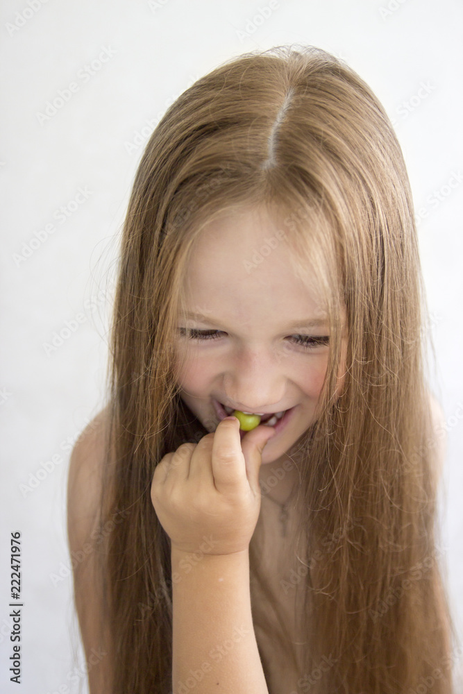 on white background girl eating grape hand feeding on white background girl eating grape hand feeding