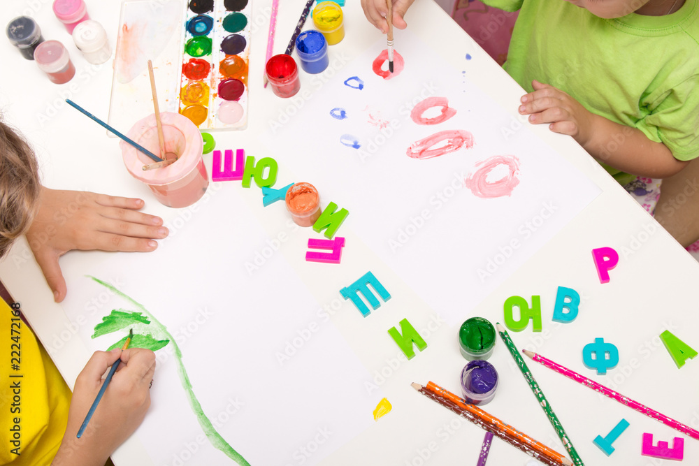 Children paint with gouache, paints , pencils. Mobile and entertainment Board games for children.Ceramic dishes in working process. Creating color patterns. Children paint with gouache, paints , pencils. Mobile and entertainment Board games for children.Ceramic dishes in working process. Creating color patterns.