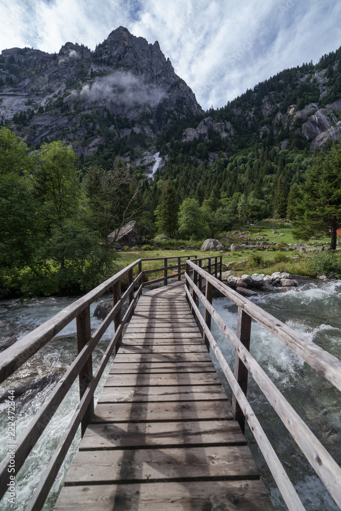 Wood bridge in the middle of the Mello Valley in Lombardy (Val di mello Sondrio).