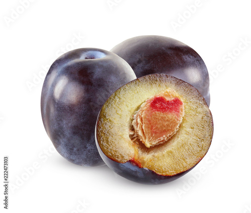 Isolated purple plums. Two whole fruits and half.