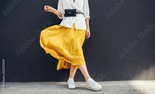 Bilde på lerret Horizontal cropped image of stylish slim woman in beautiful yellow skirt