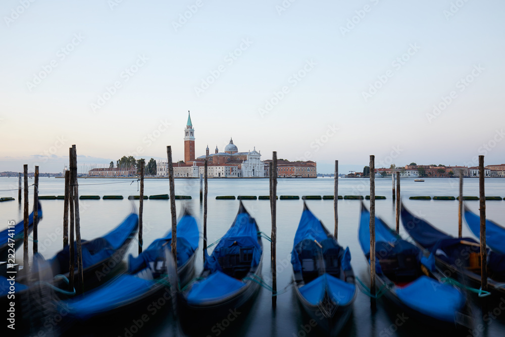 Gondolas and San Giorgio Maggiore basilica in Venice before sunset, Italy