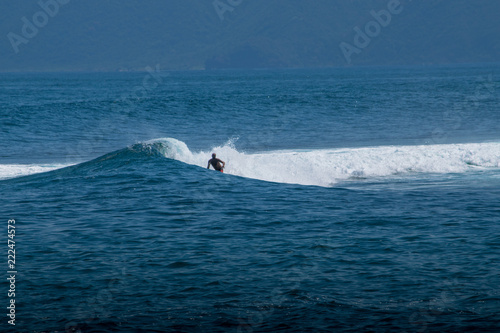 surfer cobblestone sumbawa leaky peak wave ocean
