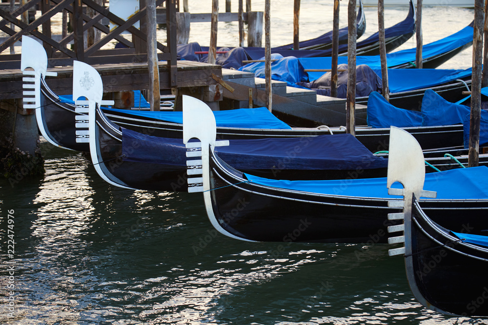Gondola boats moored in Grand Canal in Venice in the early morning, Italy