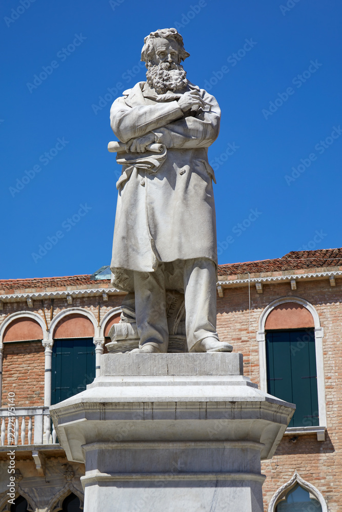 Obraz premium Niccolo Tommaseo statue in Venice by Francesco Barzaghi (1839-1892), clear blue sky in Italy