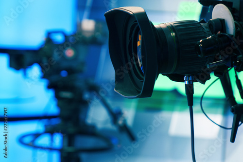 Broadcast television studio camera and crane camera in news studio room with LED lights