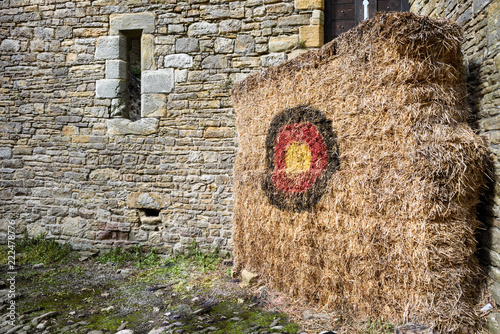 Traditional archery target practice in a medieval setting.