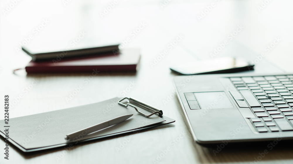 business palnning and strategy development. office workspace with laptop clipboard and pen business palnning and strategy development. office workspace with laptop clipboard and pen
