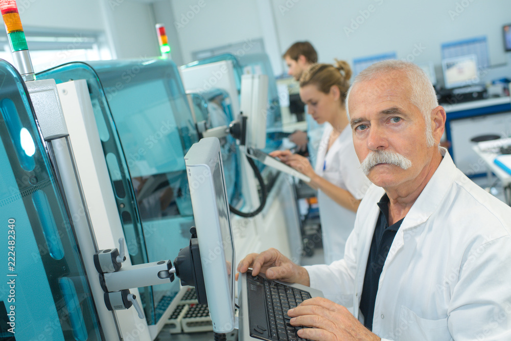 senior doctor looking at ct scanner in hospital laboratory