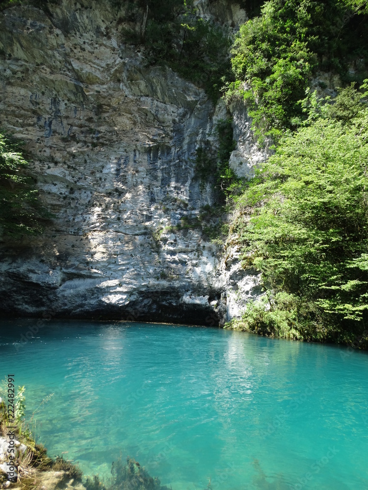 The blue lagoon in the mountains. Clean and fresh water in a deep lake. A beautiful mountain landscape for relaxation. Adventure in the mountains near the water The blue lagoon in the mountains. Clean and fresh water in a deep lake. A beautiful mountain landscape for relaxation. Adventure in the mountains near the water