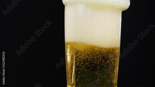 4k close up focus at beer bubble in a glass on black background