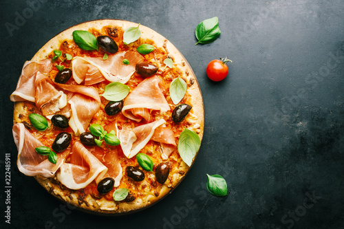 Traditional italian pizza on dark table