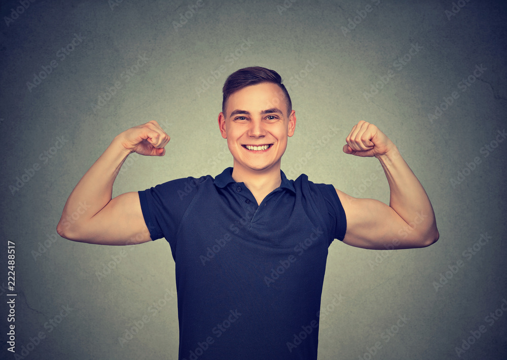 Fototapeta premium Strong young man showing biceps