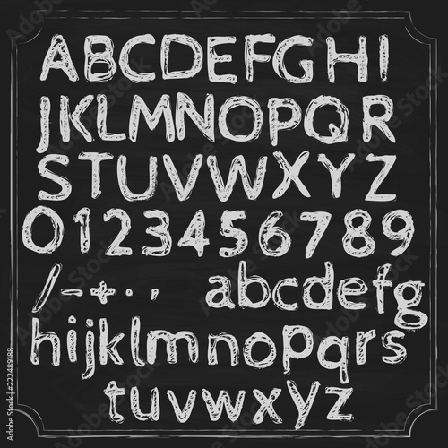 Alphabet written chalk on a blackboard. Letters in two registers and numbers. Punctuation marks.