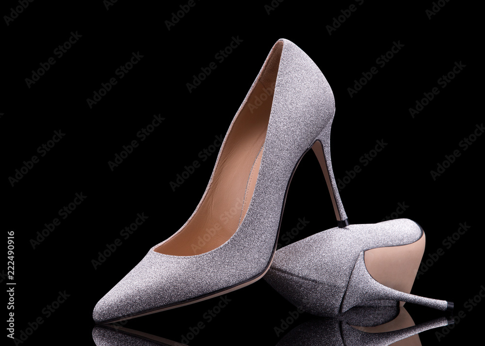 Elegant silver shoes on a black background. Evening Party Shoes. Elegant silver shoes on a black background. Evening Party Shoes.