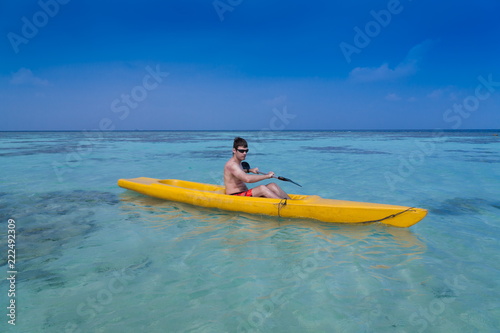 Maldives,  man in canoe © erainbow