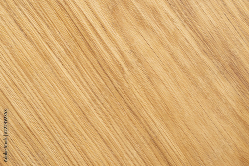 Diagonal textured light colored wood background.