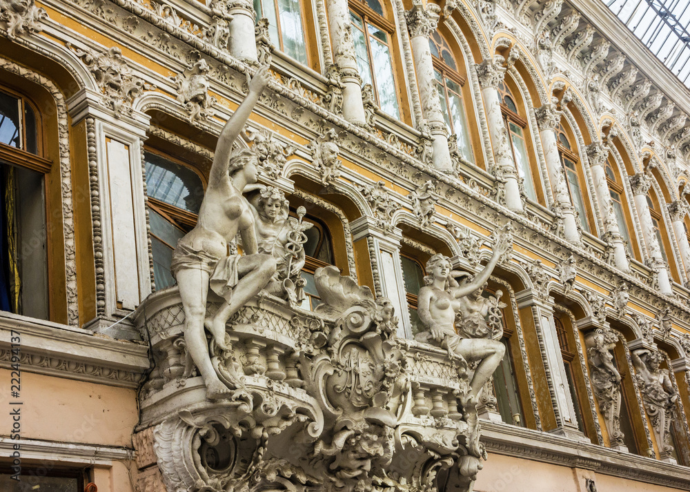 Odessa, Ukraine: balcony sculptures, passage - old covered mall and architectural monument.