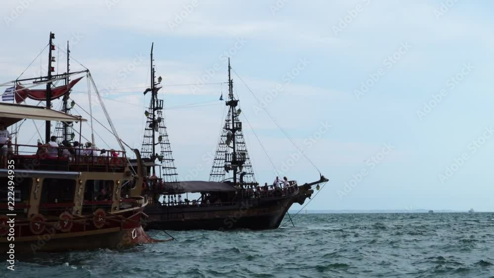 Close up view on two ancient retro sail ships tourist attractions meeting in calm ocean waves in endless horizon skyline Close up view on two ancient retro sail ships tourist attractions meeting in calm ocean waves in endless horizon skyline