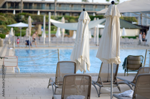 View pool bed, beach chair with umbrellas chaise lounges near the pool photo