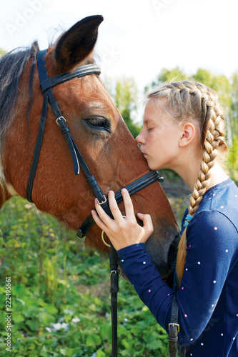 Portrait of young horsewoman and brown horse. Girl with horse. © natasnow