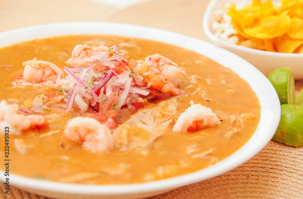 Close up of selective focus of Ecuadorian food: shrimp cebiche with some blurred chifles background Close up of selective focus of Ecuadorian food: shrimp cebiche with some blurred chifles background