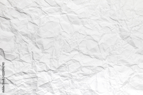 Background or pattern of Wrinkled white rectangular paper with rough texture.