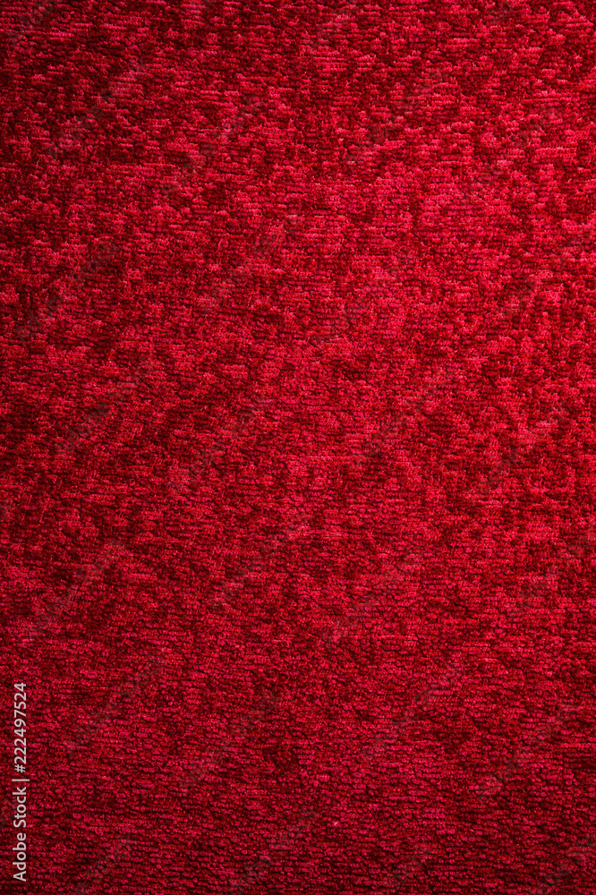 Fototapeta premium Texture of a dark red carpet. Close-up of gradient light