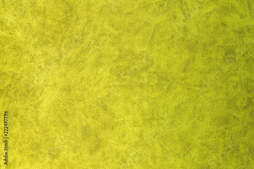Yellow patterned surface of velvet fabric on top. Texture of artificial cloth