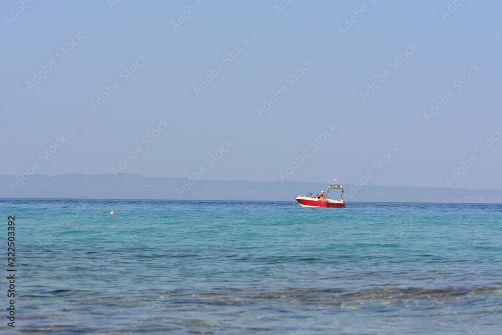 Afytos beach in Greece, rocks and blue sea