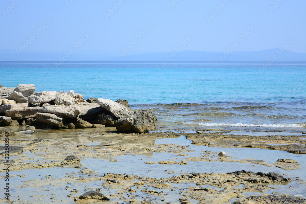 Afytos beach in Greece, rocks and blue sea Afytos beach in Greece, rocks and blue sea