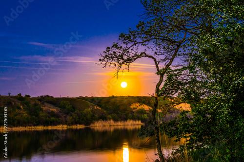 Very beautiful and colorful night and evening landscapes over the river Seversky Donets in the Rostov region. A rich moonlit sunset like a sunset  a hot hue with bright colors of nature