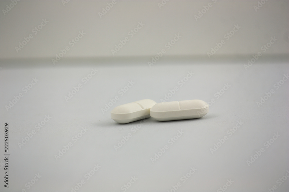 Some pills on a neutral background