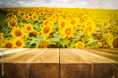 Fototapeta Naklejka Na Ścianę i Meble -  beautiful sunflowers and an old wooden table  