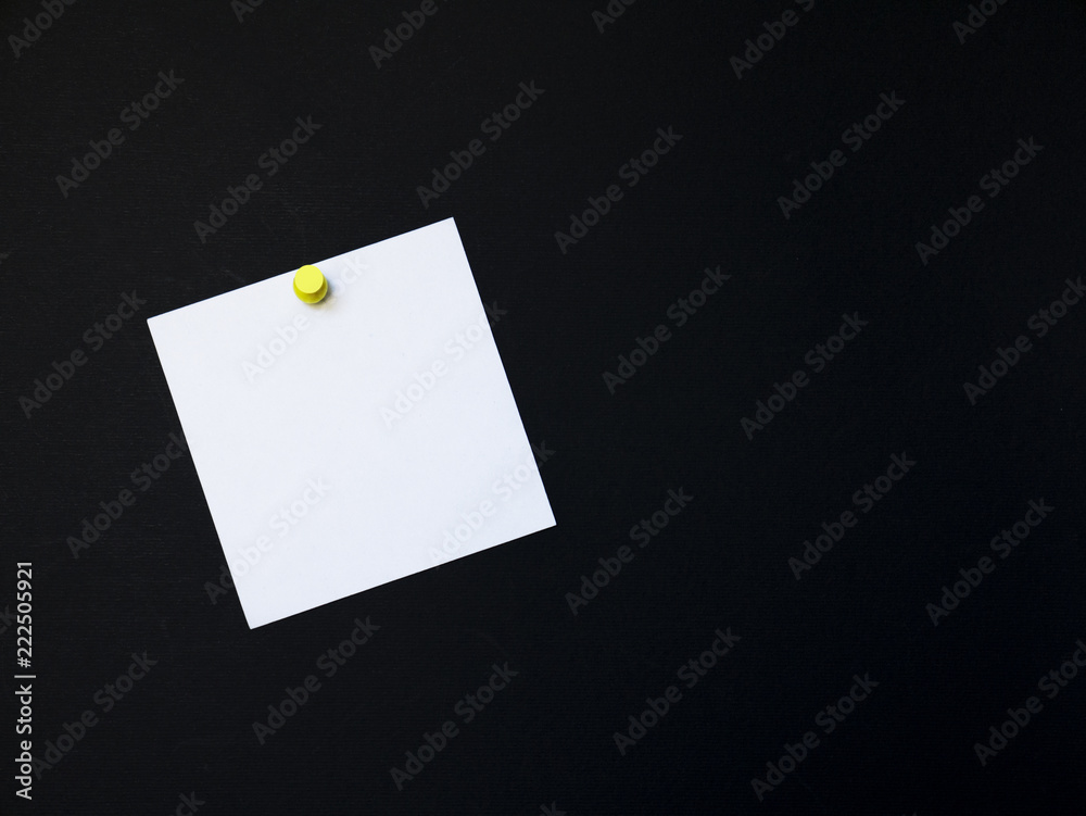 Notes stick nailed in yellow button on a black background Notes stick nailed in yellow button on a black background