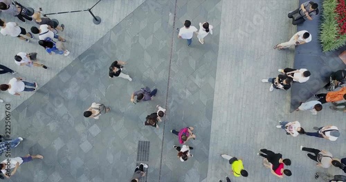 SHENZHEN, CHINA - CIRCA MARCH, 2018: crowds of people crossing the shopping street at the center of metropolis, aerial view