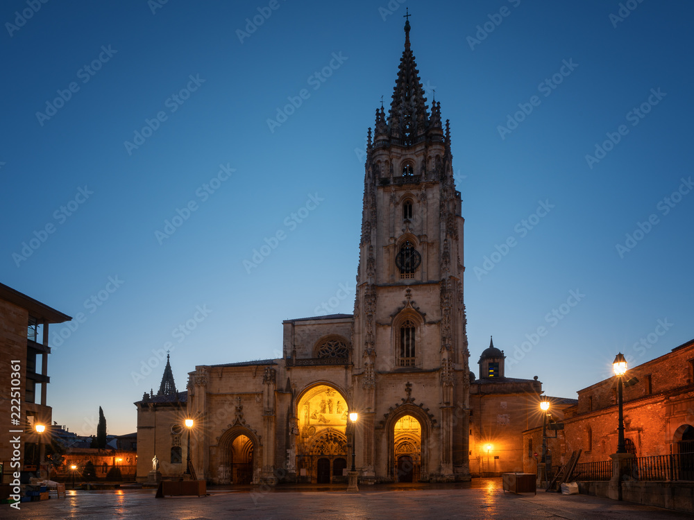 Illuminated cathedral of Oviedo with blue sky at daybreak, Spain