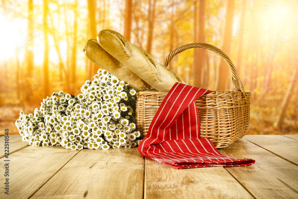 autumn wooden table with a wicker basket for an advertising product  