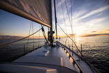 Sailing at sunset. A view from the yacht's deck to the bow and sails, Baltic sea, Latvia