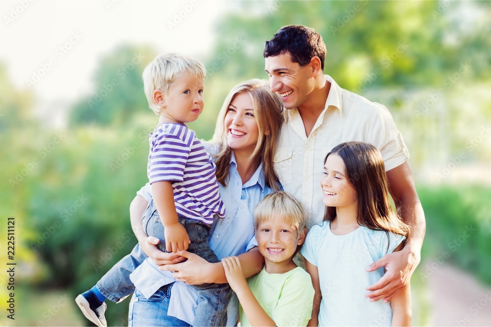 Parents Giving Children Piggybacks In Countryside