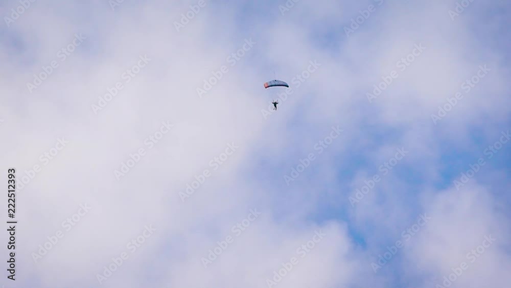a parachute and a man in the sky. a parachute and a man in the sky.
