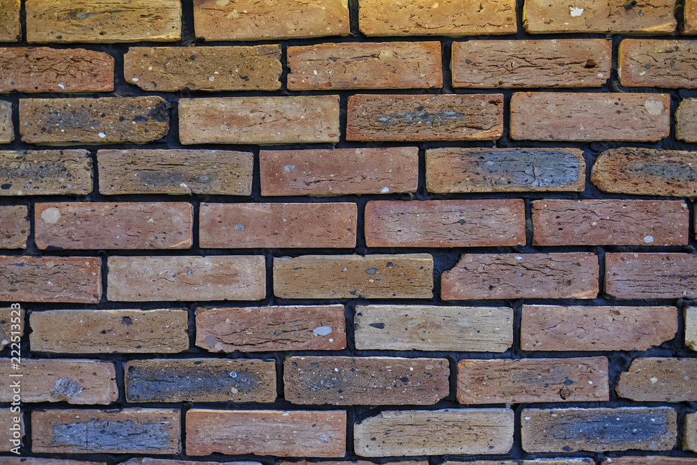 Fototapeta premium Vintage cleaned red brick wall. Empty background of horizontal brickwork.