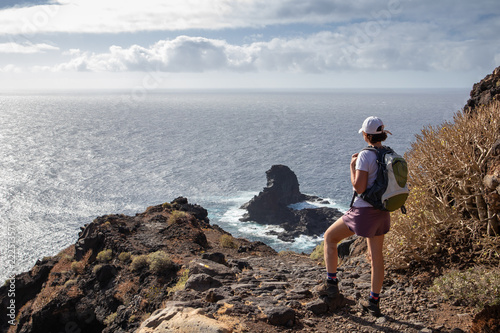 The traveler admires the panoramic view of the island from the viewpoint "Roque de Santo Domingo. Wild walking tours on the island of La Palma Canary Islands.