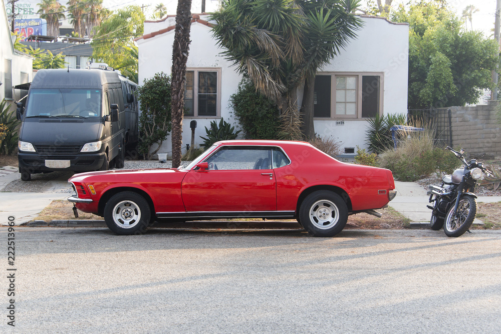 Fototapeta premium A view of a vintage classic American red car in the street in LA
